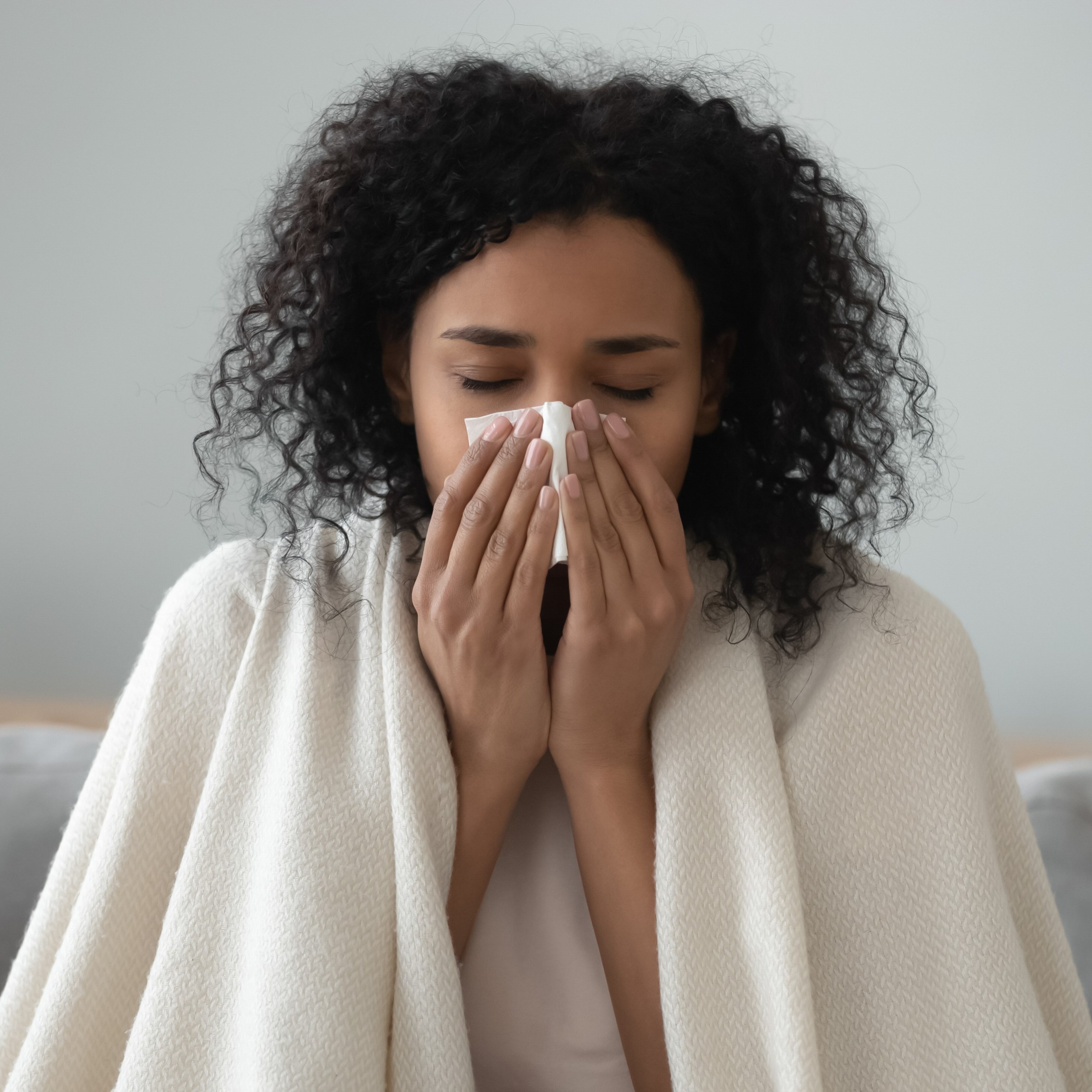 woman blowing her nose