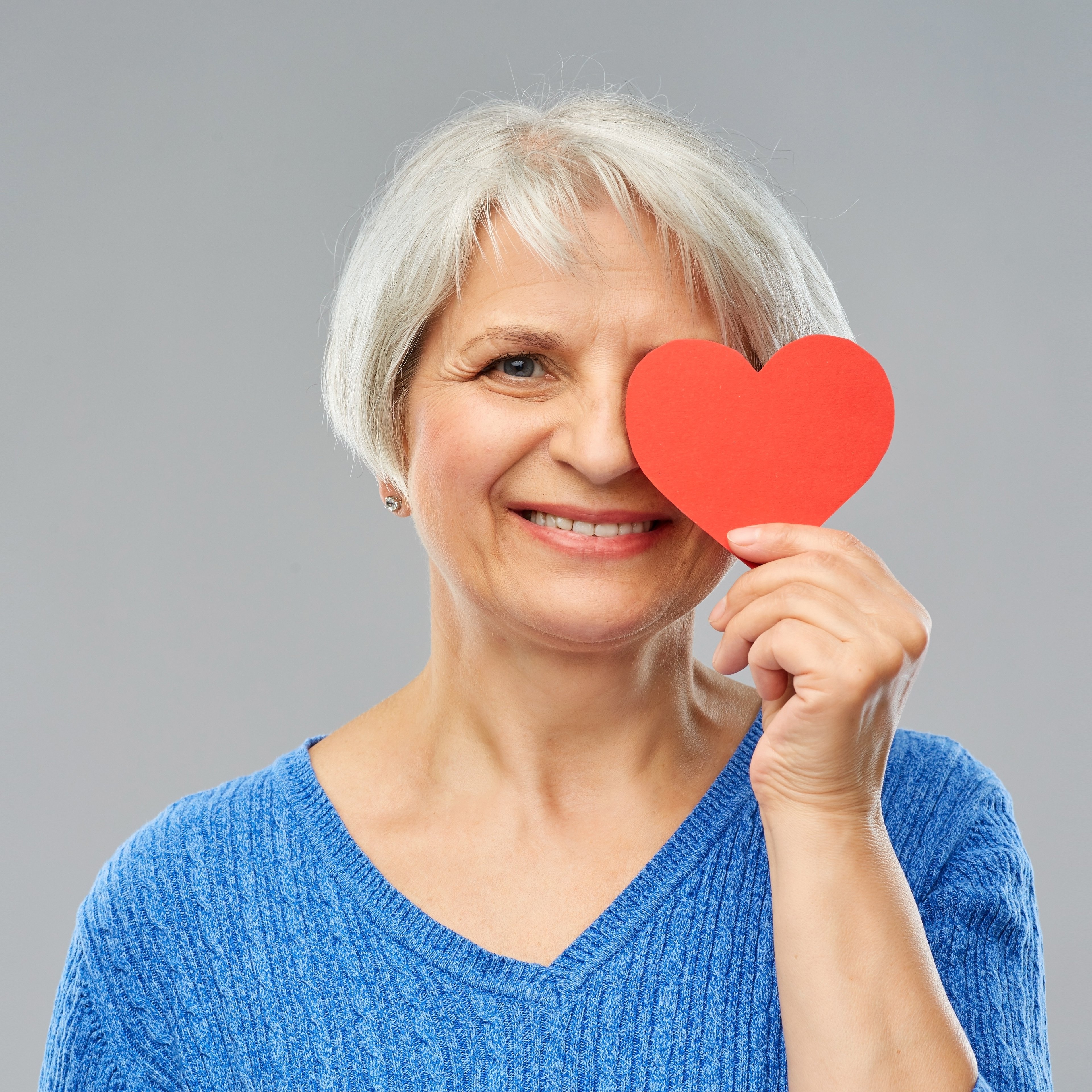 lady holding heart over eye