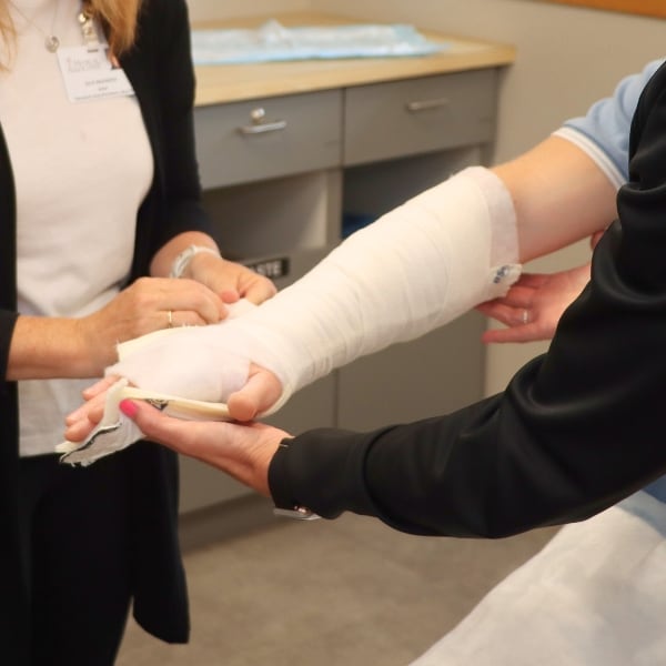 Doctor putting cast on patient